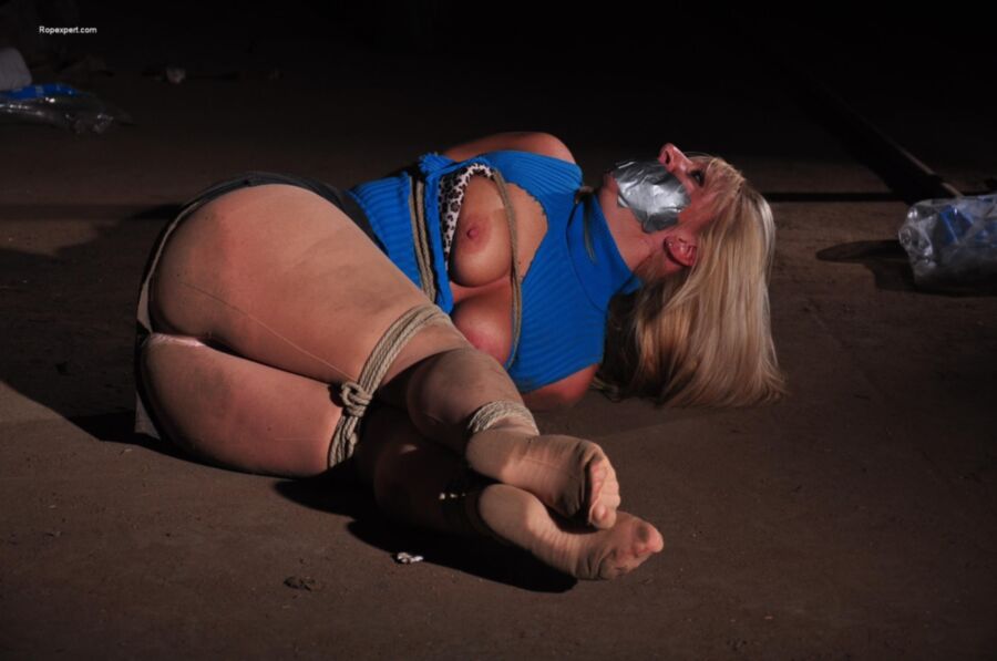 Free porn pics of Blonde tape gagged on the basement floor 19 of 38 pics