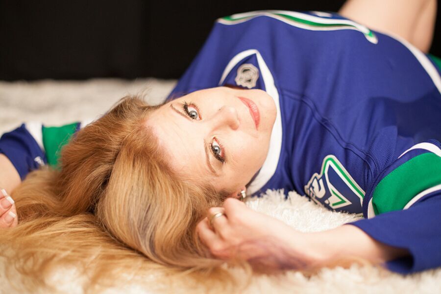 Free porn pics of Woman does boudoir shoot in hockey jersey & glasses 15 of 22 pics