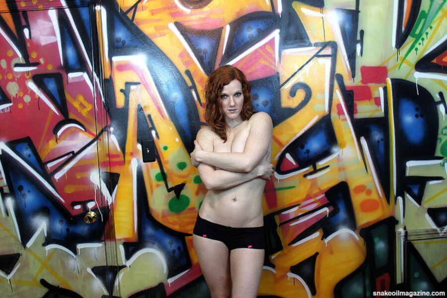 Free porn pics of Sexy Topless Redhead Model Posing in Front of Graffiti 17 of 26 pics