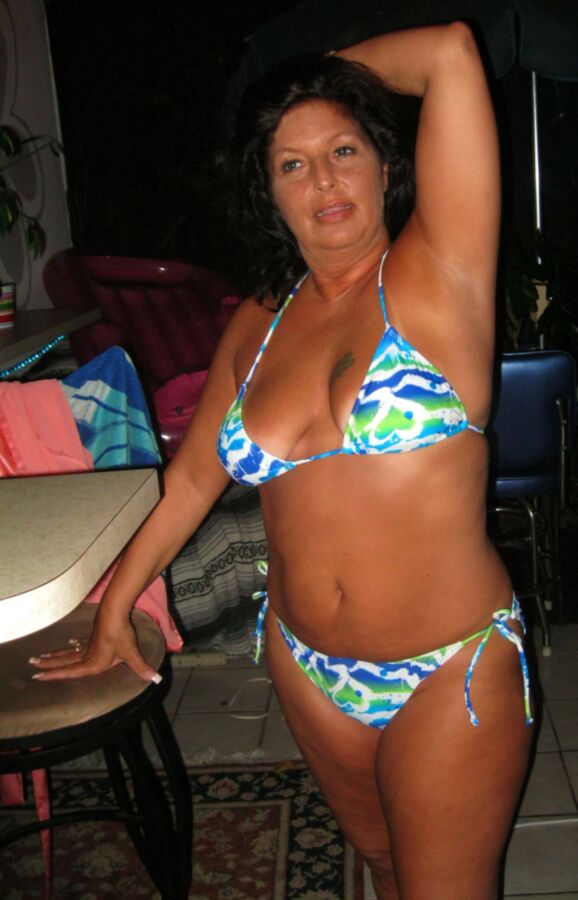 Free porn pics of Chubby milf shows off new bikinis on patio bar. 3 of 143 pics