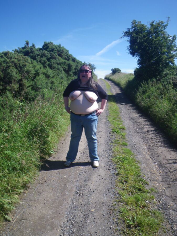 Free porn pics of BBW wife in the country, showing off her tits and belly 15 of 17 pics