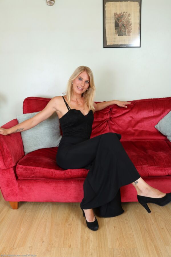 Free porn pics of Mature blond Jentina poses on her red couch. 3 of 170 pics