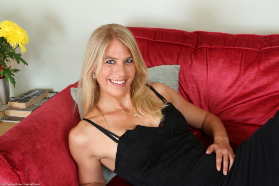 Free porn pics of Mature blond Jentina poses on her red couch. 19 of 170 pics