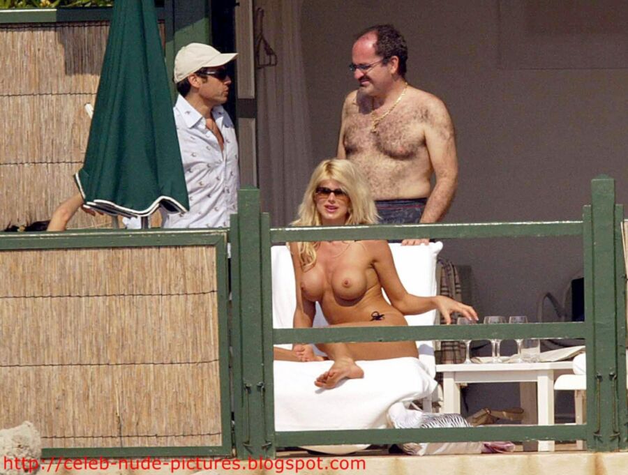 Free porn pics of Victoria Silvstedt topless sunbathing 12 of 13 pics