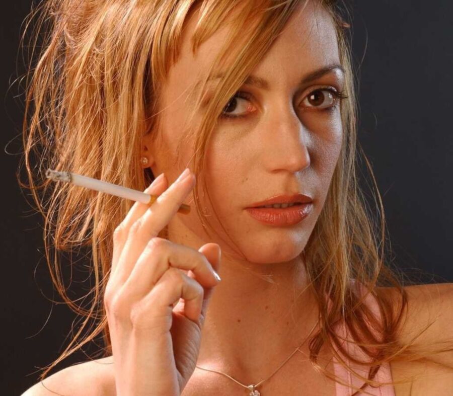 Free porn pics of Beautiful sexy redhead smoking cigarettes. 2 of 5 pics