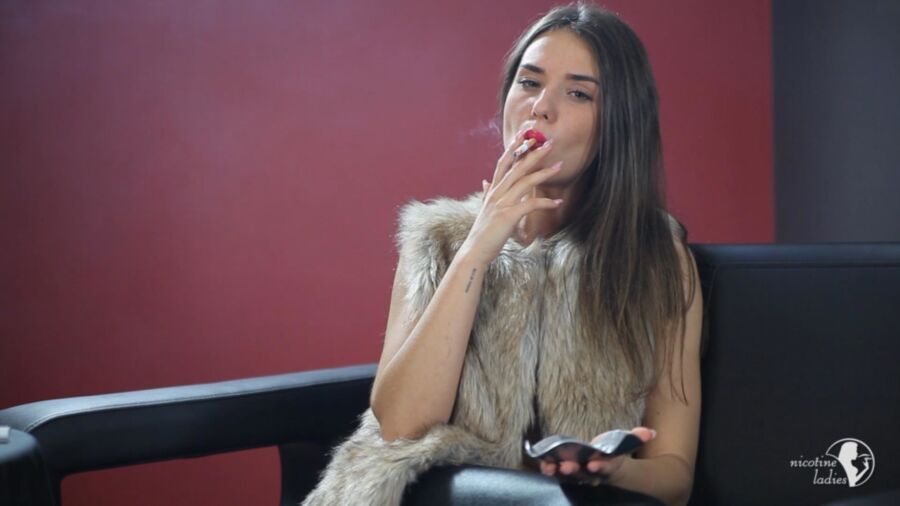 Free porn pics of Stunning brunette smoking a cigarette. 3 of 10 pics