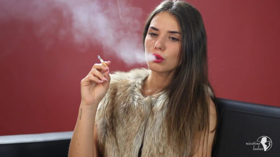 Free porn pics of Stunning brunette smoking a cigarette. 4 of 10 pics