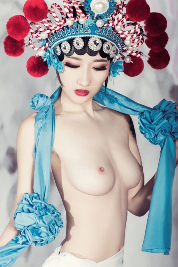 Nude woman wearing a traditional ethnic Chinese costume. 