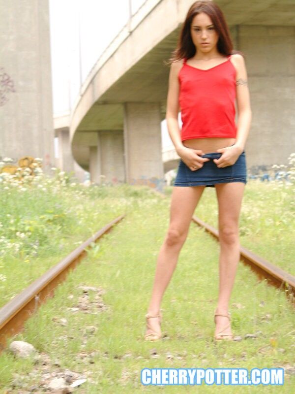 Free porn pics of Cherry Petite getting naked on an abandoned rail road 2 of 125 pics