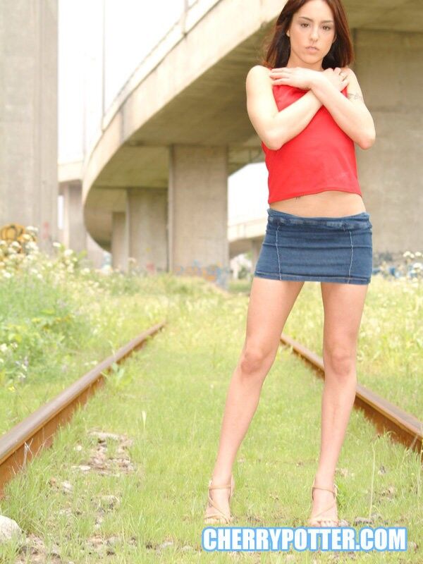 Free porn pics of Cherry Petite getting naked on an abandoned rail road 5 of 125 pics