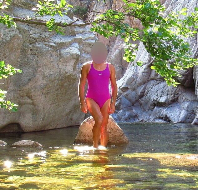 Free porn pics of Young woman in one piece swimsuit on a mountain river in the Alp 2 of 16 pics
