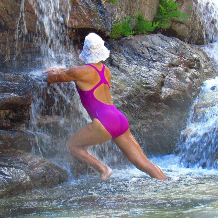 Free porn pics of Young woman in one piece swimsuit on a mountain river in the Alp 16 of 16 pics