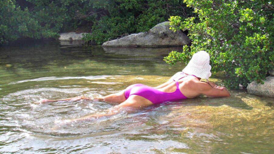 Free porn pics of Young woman in one piece swimsuit on a mountain river in the Alp 6 of 16 pics
