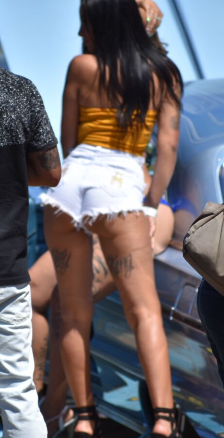 Free porn pics of Car show Latina in white booty shorts and a yellow top 9 of 17 pics