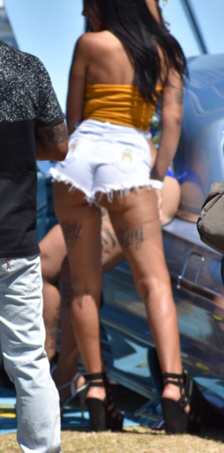 Free porn pics of Car show Latina in white booty shorts and a yellow top 8 of 17 pics