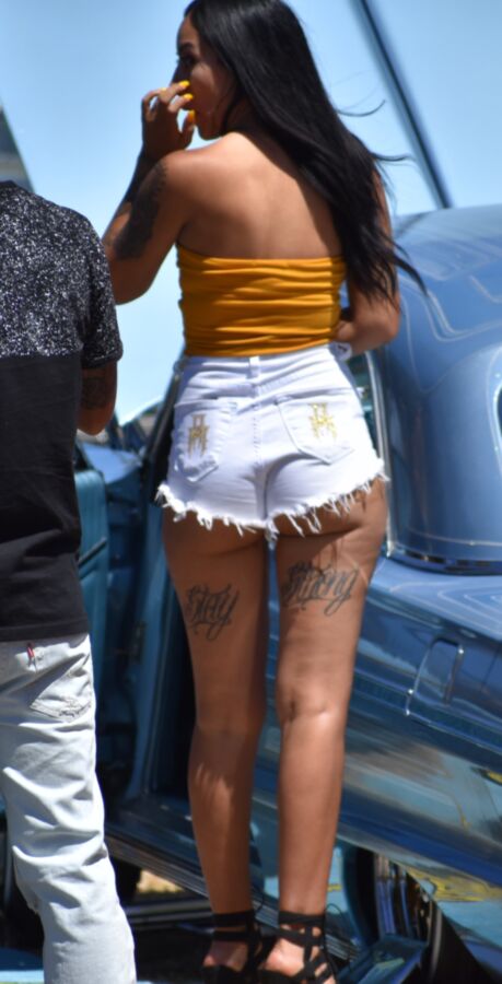 Free porn pics of Car show Latina in white booty shorts and a yellow top 7 of 17 pics