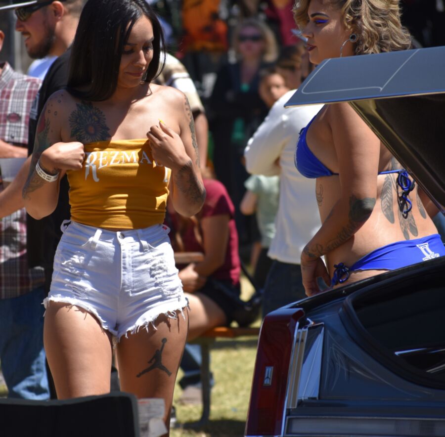 Free porn pics of Car show Latina in white booty shorts and a yellow top 14 of 17 pics