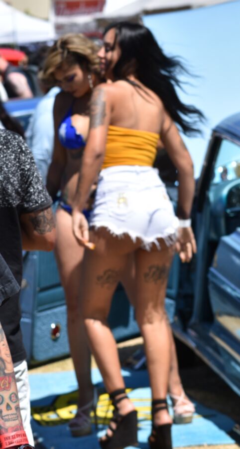 Free porn pics of Car show Latina in white booty shorts and a yellow top 10 of 17 pics