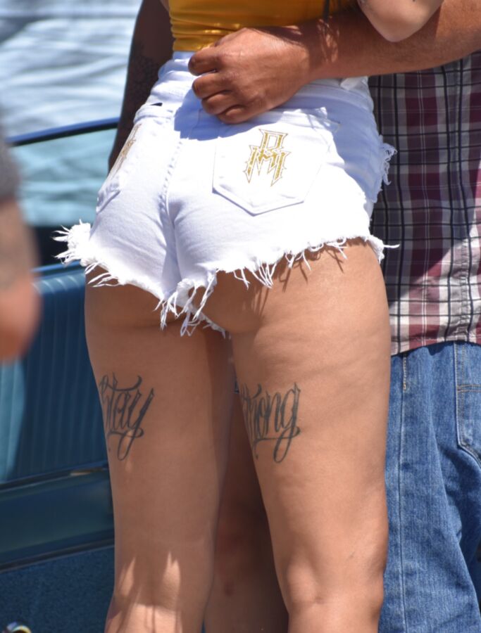 Free porn pics of Car show Latina in white booty shorts and a yellow top 5 of 17 pics