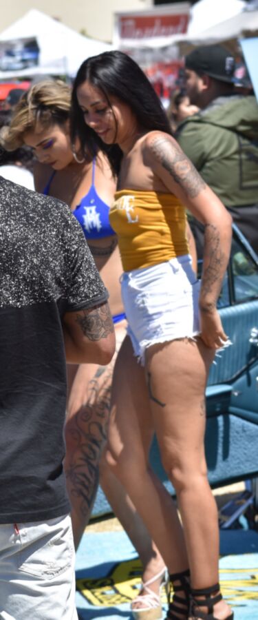 Free porn pics of Car show Latina in white booty shorts and a yellow top 11 of 17 pics