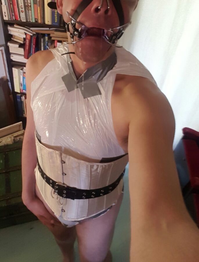 Free porn pics of Submissive sissy in plastic playsuit with spidergag 3 of 17 pics