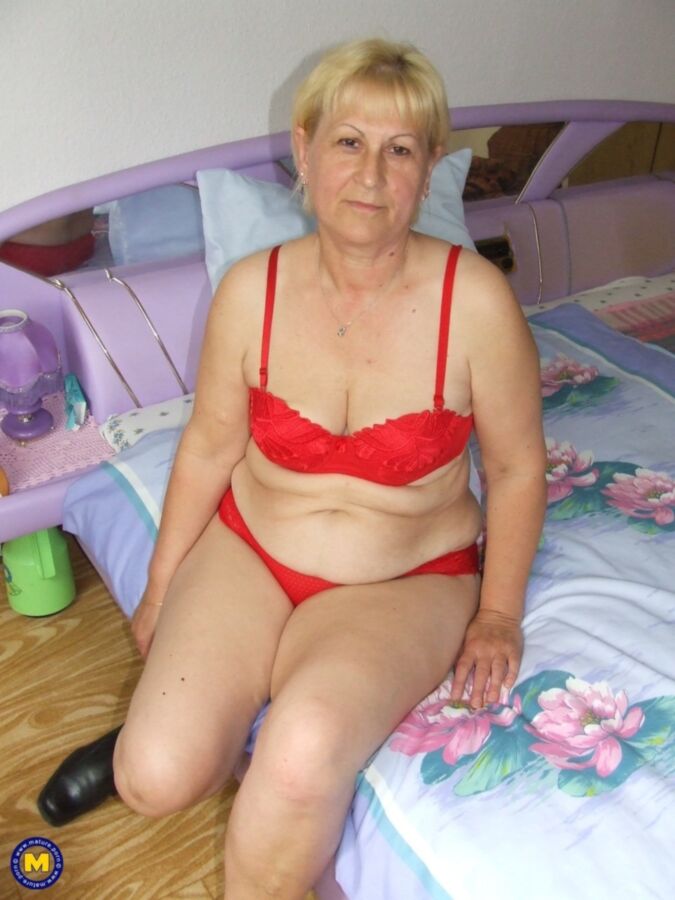 Free porn pics of Granny removes red lingerie and poses nude in bedroom 3 of 16 pics