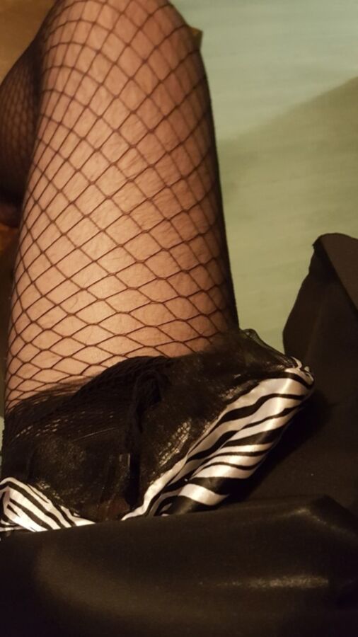 Free porn pics of Fancy sissy in fishnets and chastity 7 of 9 pics