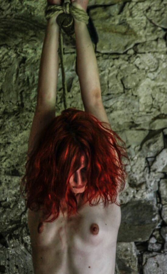 Free porn pics of Young redhead chained naked to the wall 4 of 24 pics