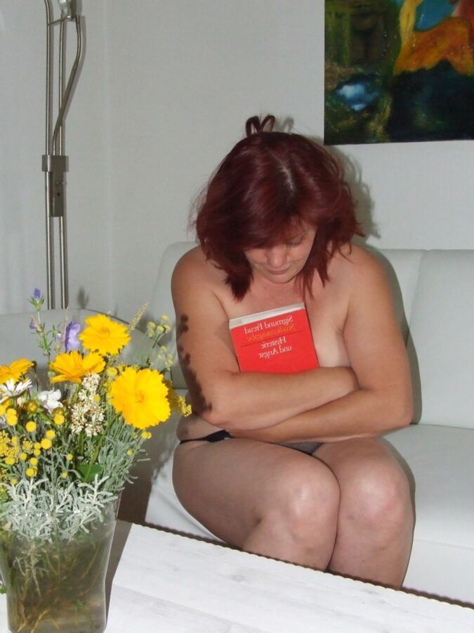 Mature redhead Julia poses on her white couch. 11 of 91 pics