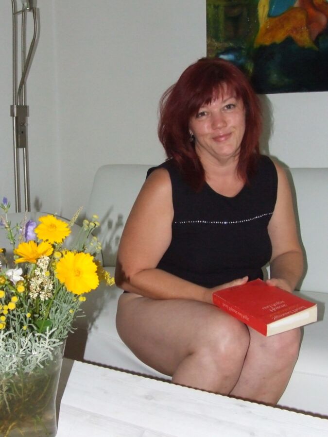 Mature redhead Julia poses on her white couch. 7 of 91 pics