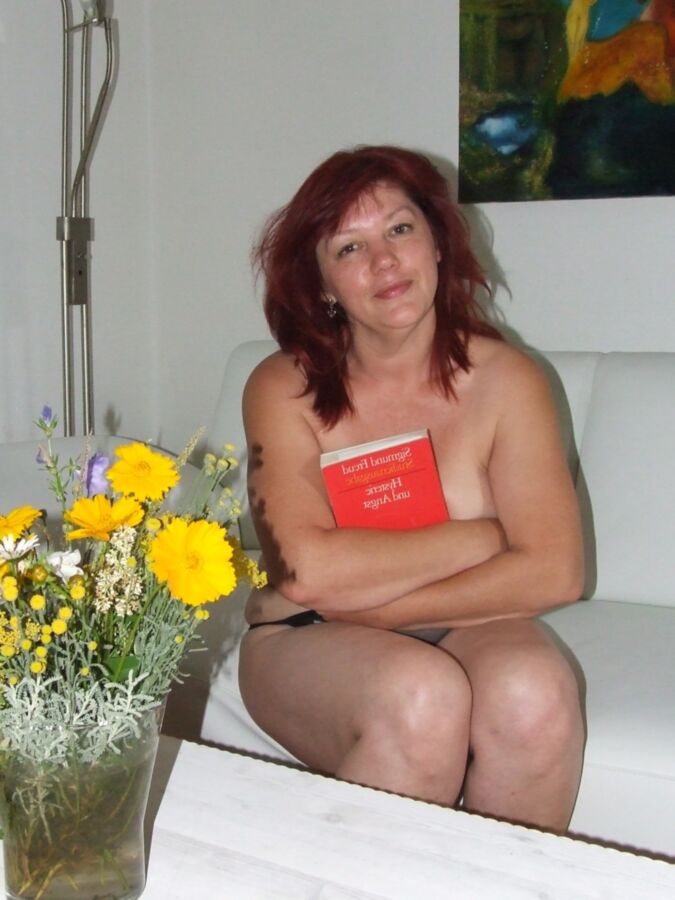 Mature redhead Julia poses on her white couch. 12 of 91 pics