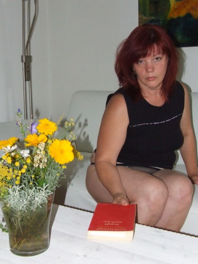 Mature redhead Julia poses on her white couch. 5 of 91 pics