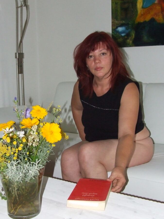Mature redhead Julia poses on her white couch. 4 of 91 pics