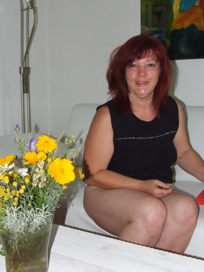 Mature redhead Julia poses on her white couch. 8 of 91 pics