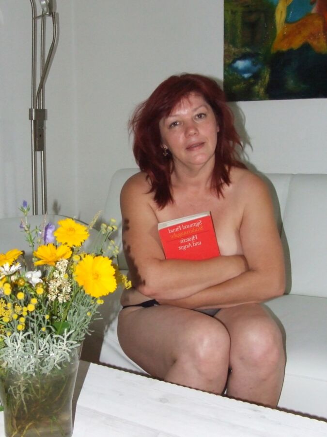 Mature redhead Julia poses on her white couch. 13 of 91 pics