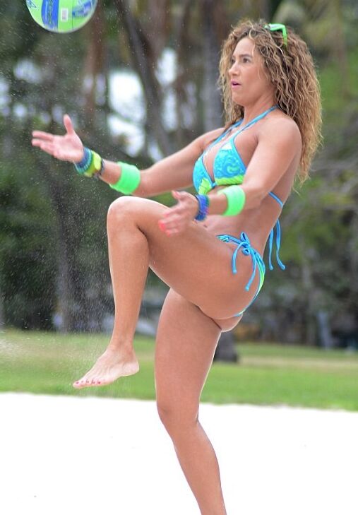 Jennifer Nicole Lee wearing a bikini, playing beach volleyball 6 of 12 pics