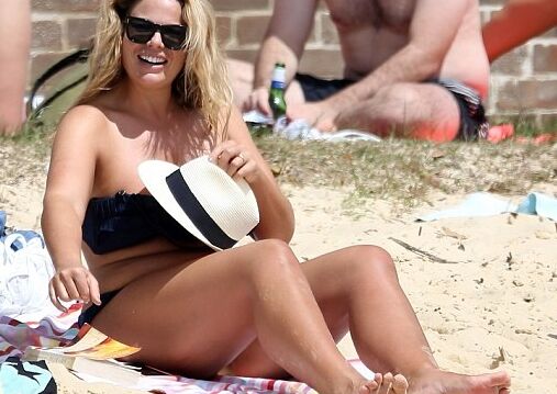 Fiona Falkiner shows off her curves in a tiny two piece at Beach 2 of 15 pics