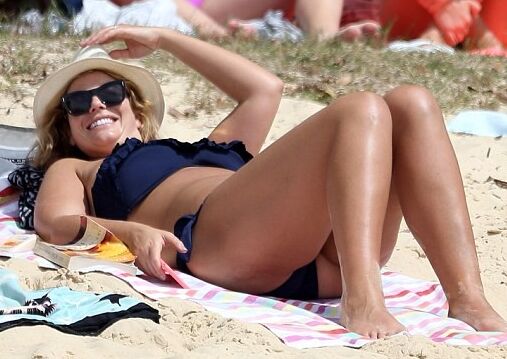 Fiona Falkiner shows off her curves in a tiny two piece at Beach 3 of 15 pics