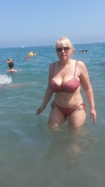 Sexy and a busty mature MILF fucked on the beach