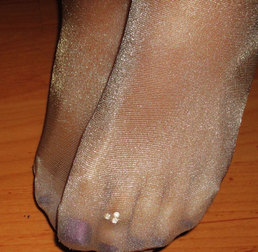 Wifes feet in shiny tan pantyhose