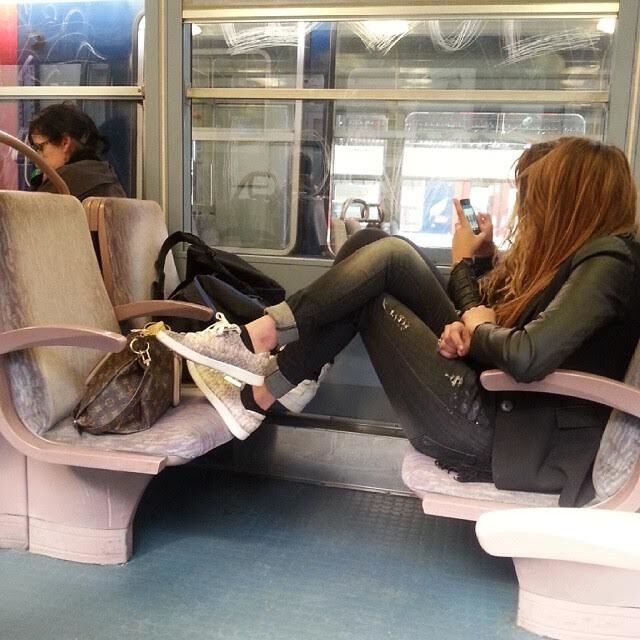 Feet on train seats France Edition.